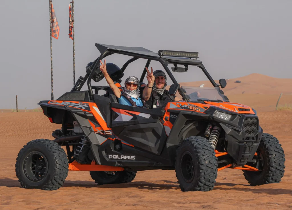 dune buggy dubai red dunes at sunset